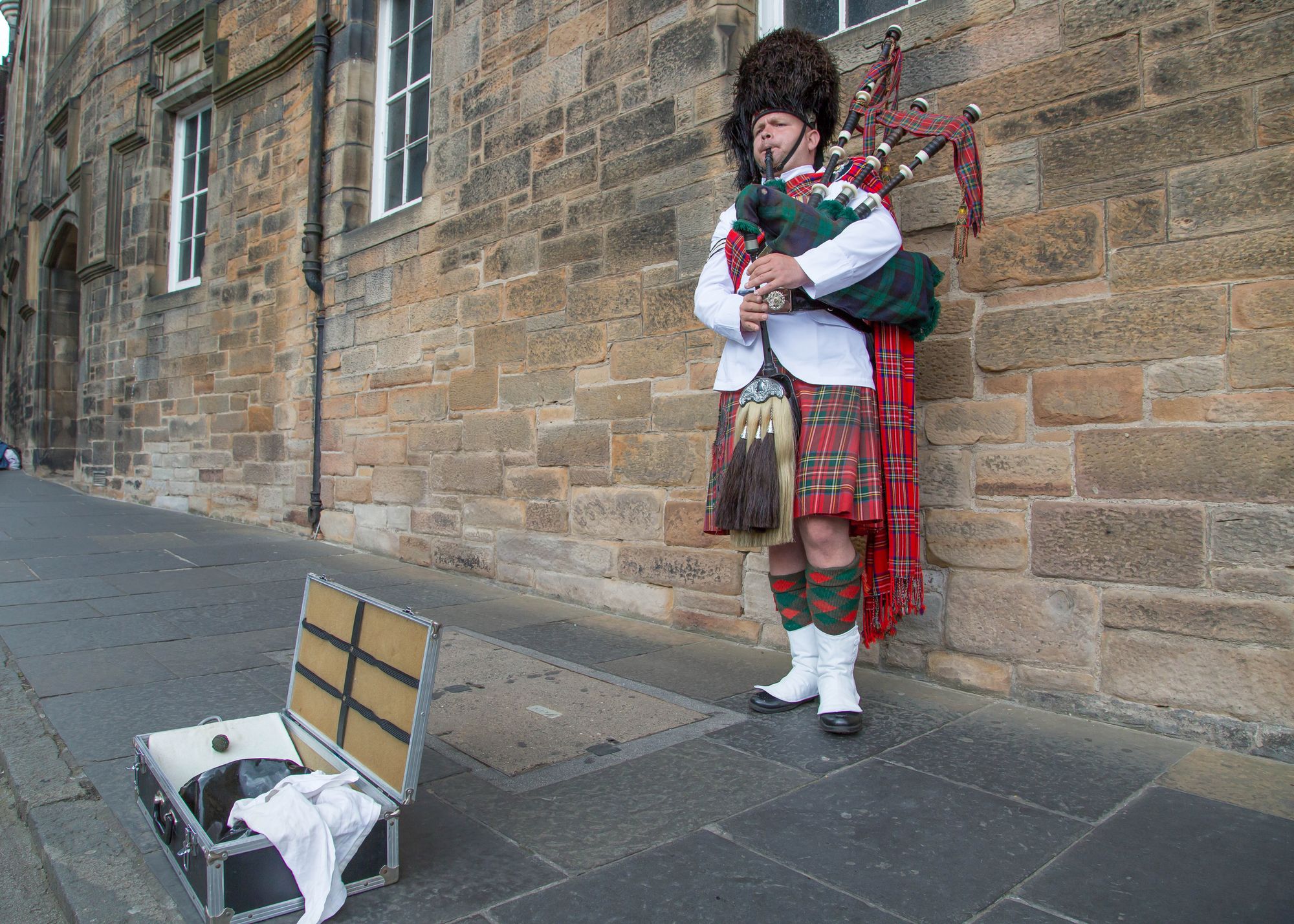 A man plays the bagpipes on the Royal Mile in Edinburgh