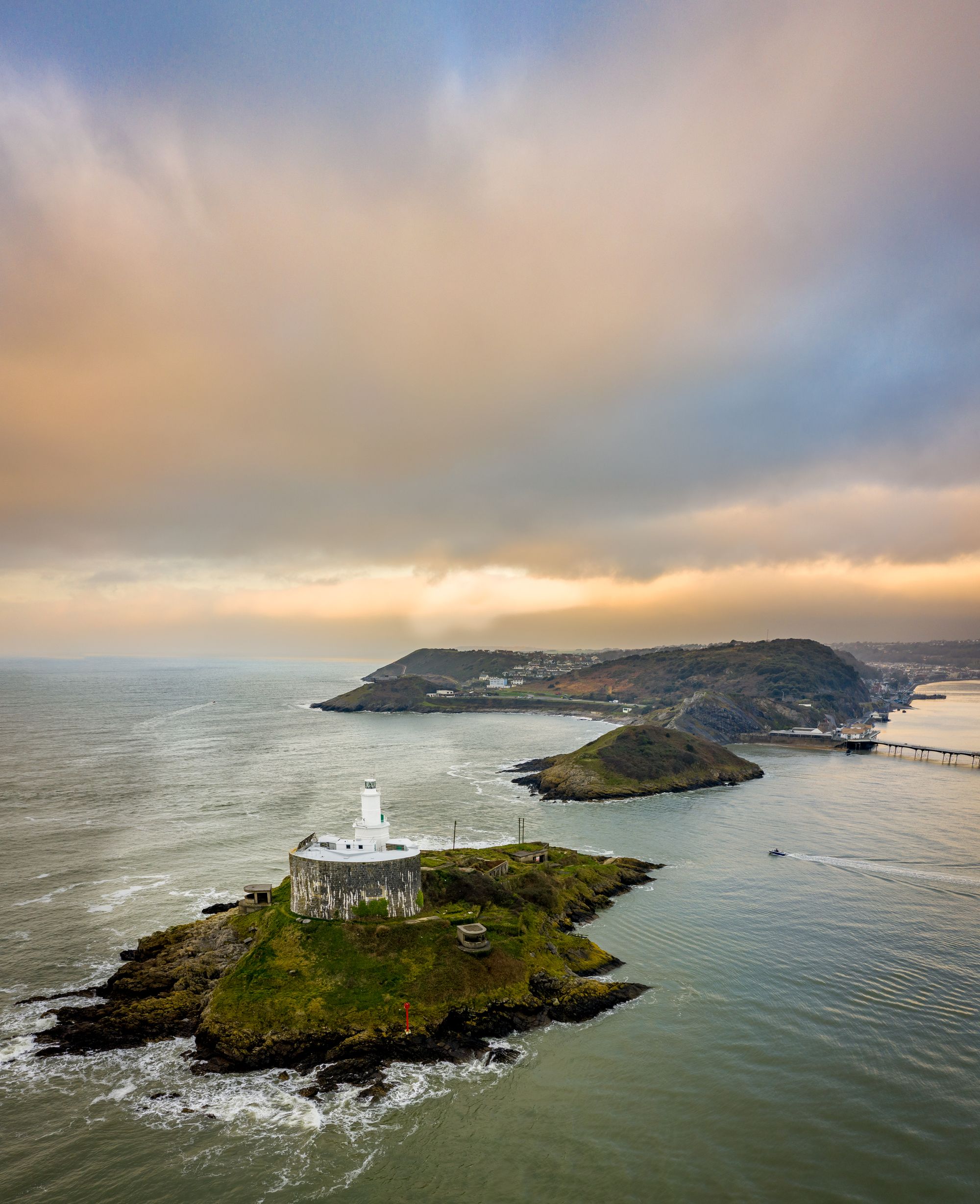 Arial view of a Offshore island with lighthouse on Mumbles Head in Swansea Bay